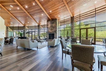 8853 Hollyhock Ct, Corona, CA 92883 - common area with floor to ceiling windows, wooden ceiling, beam ceiling, and a towering ceiling