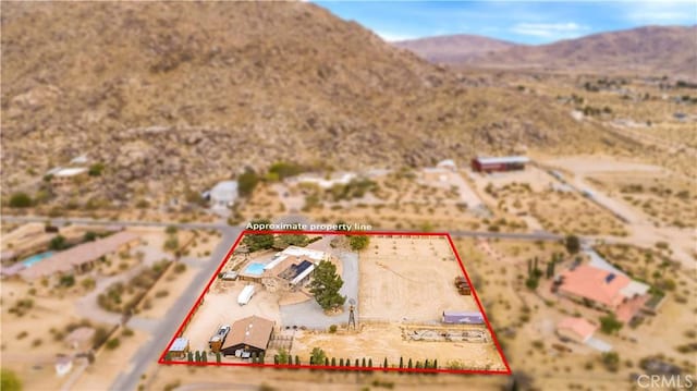 drone / aerial view featuring a mountain view and view of desert