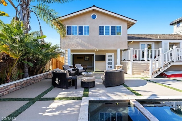 rear view of house with a fenced in pool, an outdoor living space with a fire pit, fence, stucco siding, and a patio area