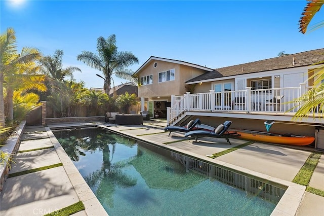 view of swimming pool featuring stairway, an outdoor hangout area, a patio, and fence