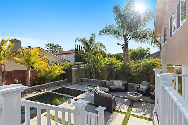 view of patio featuring an outdoor living space with a fire pit and a fenced backyard