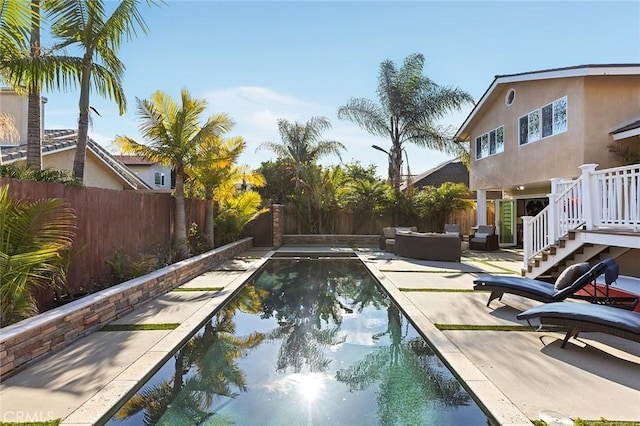 view of swimming pool featuring a patio area, an outdoor hangout area, and a fenced backyard