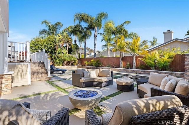 view of patio with stairway, a fenced backyard, and outdoor lounge area