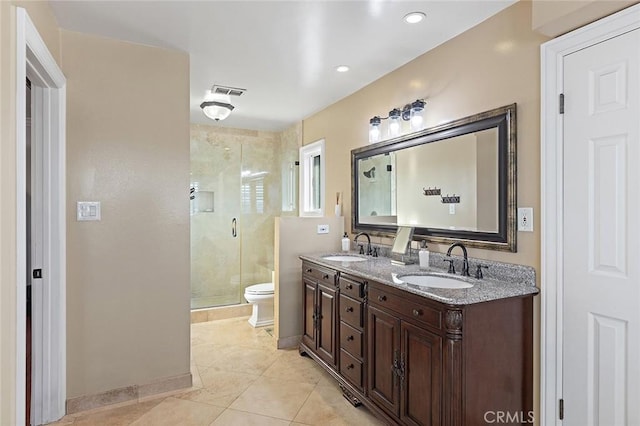 full bathroom featuring visible vents, toilet, a stall shower, a sink, and double vanity