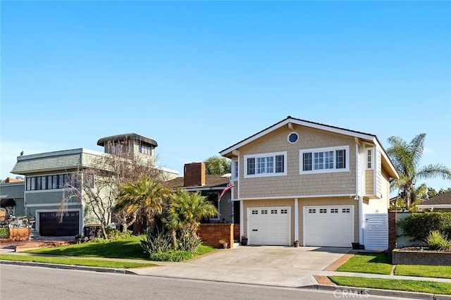 view of front facade with concrete driveway and an attached garage