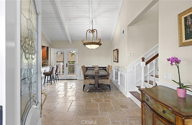 foyer entrance featuring visible vents, beamed ceiling, stairs, french doors, and stone tile flooring