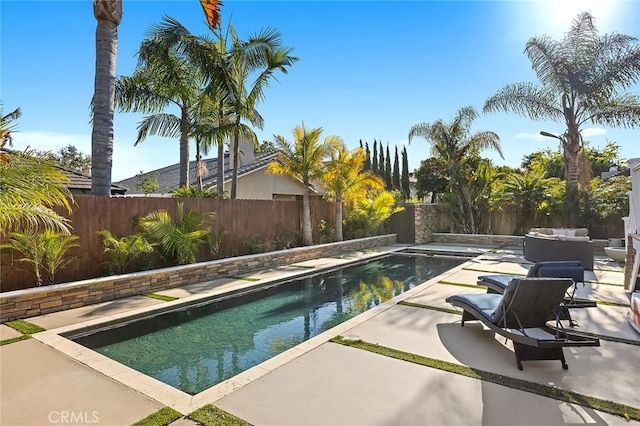 view of pool with a fenced in pool, a patio, and a fenced backyard