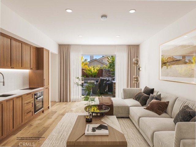 living area featuring recessed lighting and light wood-style floors