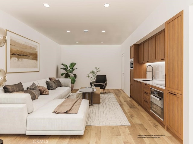 living area with light wood finished floors and recessed lighting