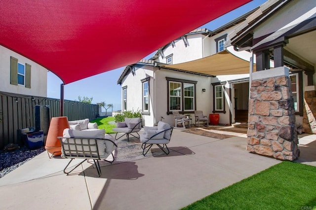 view of patio featuring an outdoor living space and fence