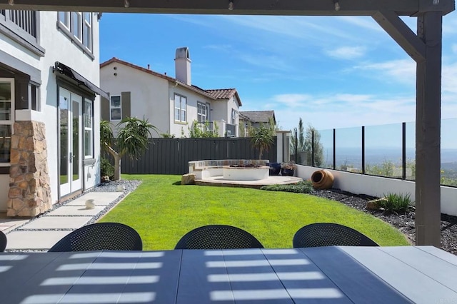 view of yard featuring a patio area, outdoor dining area, a fenced backyard, and an outdoor fire pit