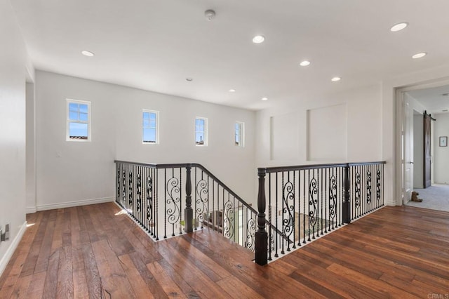 hallway featuring an upstairs landing, recessed lighting, and hardwood / wood-style floors