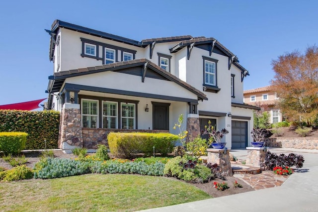 view of front facade featuring an attached garage, stone siding, driveway, and stucco siding