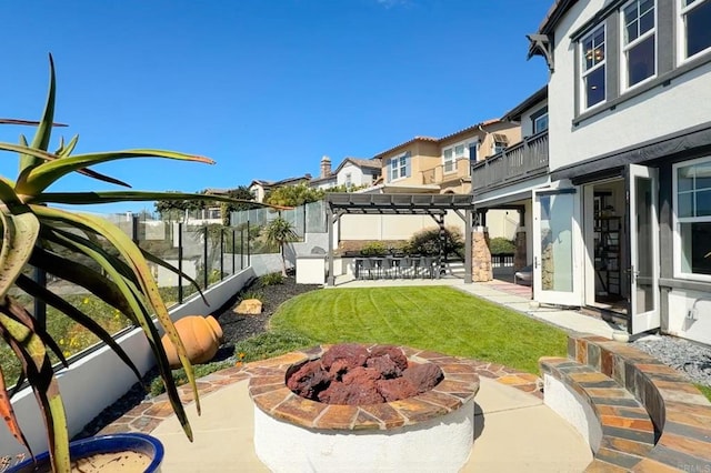 view of yard with a fire pit, a residential view, a fenced backyard, a patio area, and a pergola