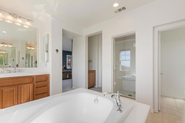 ensuite bathroom with visible vents, a garden tub, a stall shower, tile patterned flooring, and vanity