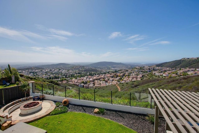 balcony featuring a mountain view and an outdoor fire pit