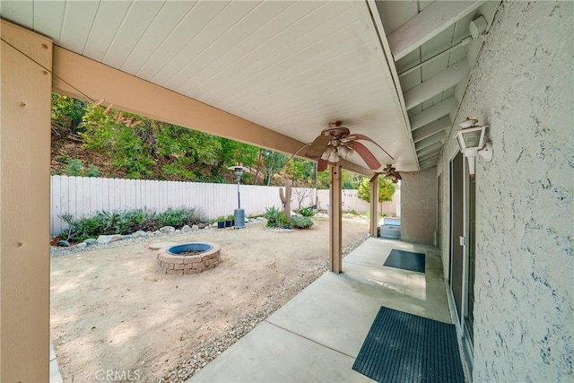 view of patio / terrace with an outdoor fire pit, a fenced backyard, and a ceiling fan