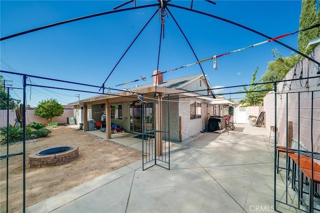 view of patio / terrace featuring an outdoor fire pit and a fenced backyard