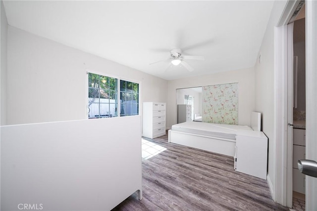 bedroom with ceiling fan and wood finished floors