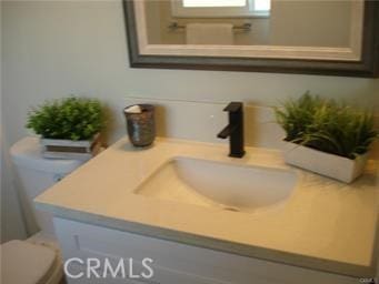 bathroom featuring toilet and vanity