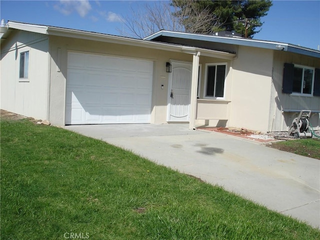 view of front of home with an attached garage, a front lawn, concrete driveway, and stucco siding