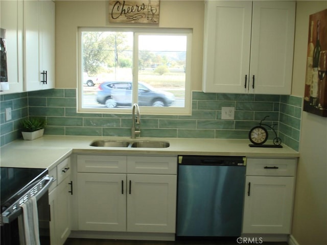 kitchen with plenty of natural light, white cabinets, dishwasher, and a sink