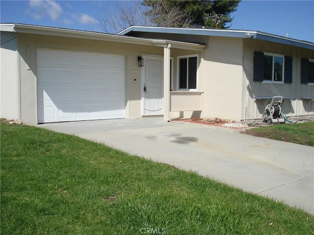 view of front of house with a garage, driveway, a front yard, and stucco siding