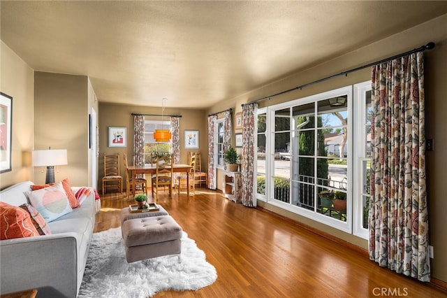 living area featuring a wealth of natural light and wood finished floors