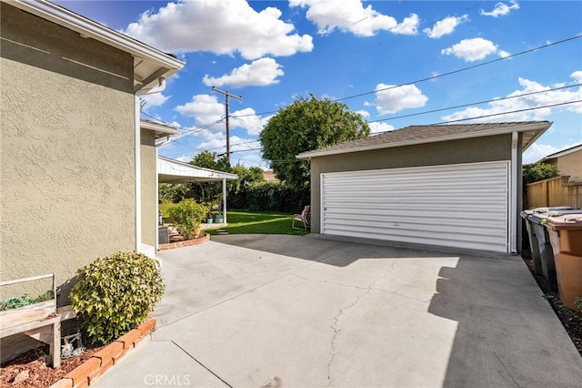 detached garage featuring fence