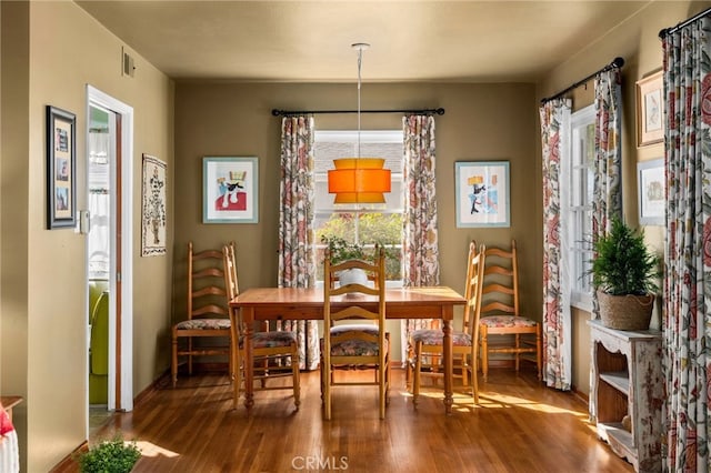 dining area with wood finished floors