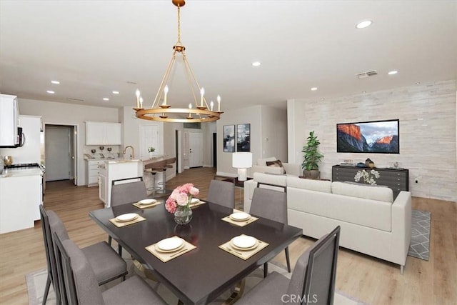 dining area with light wood finished floors, visible vents, and recessed lighting