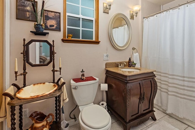 bathroom featuring tile patterned floors, a shower with curtain, toilet, and vanity