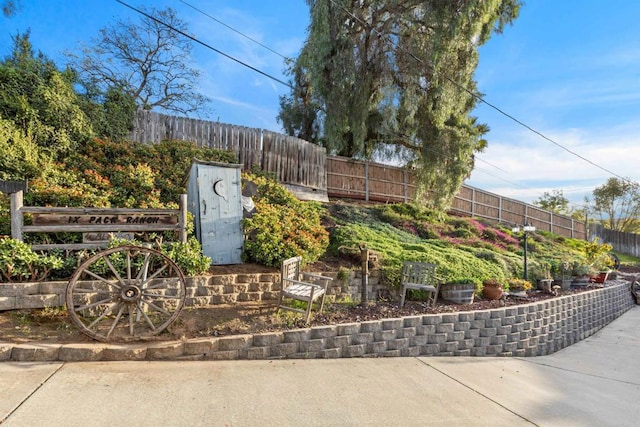 community / neighborhood sign featuring fence