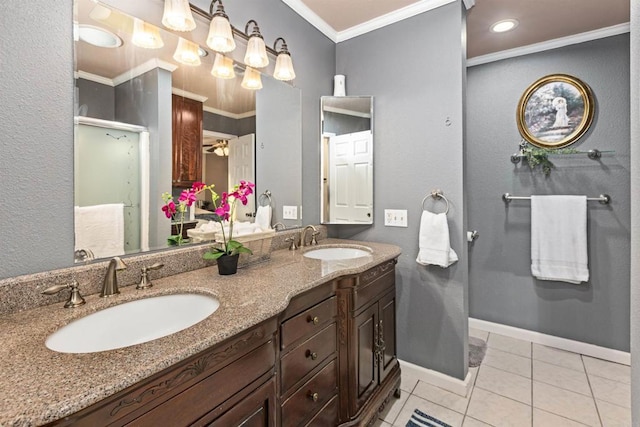 full bath with a sink, baseboards, crown molding, and tile patterned flooring