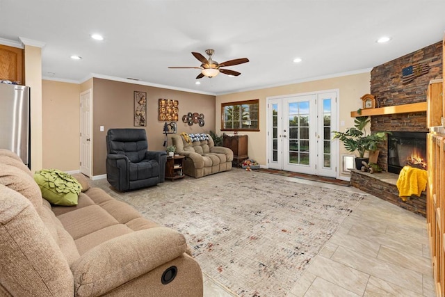 living area featuring a ceiling fan, recessed lighting, a fireplace, and ornamental molding