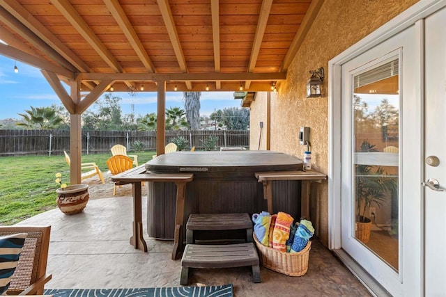 view of patio with a hot tub and a fenced backyard