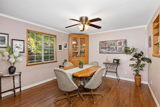 dining area featuring crown molding, wood finished floors, baseboards, and ceiling fan