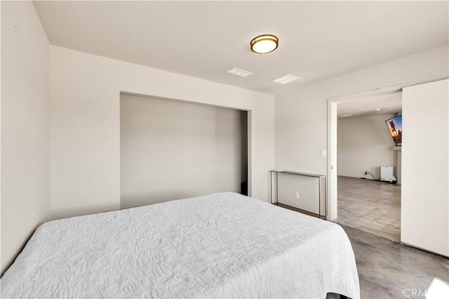 bedroom featuring concrete floors