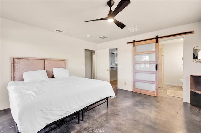 bedroom with finished concrete flooring, a barn door, and visible vents