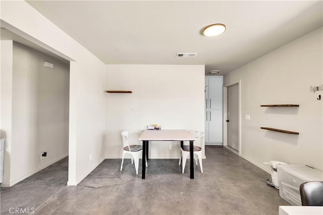 dining space with baseboards, visible vents, and concrete flooring