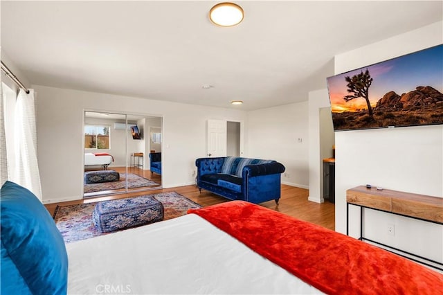 bedroom featuring baseboards and wood finished floors