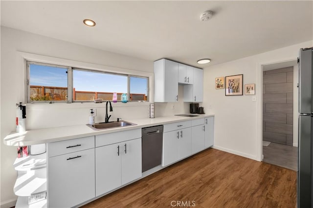 kitchen featuring freestanding refrigerator, white cabinetry, a sink, wood finished floors, and dishwasher