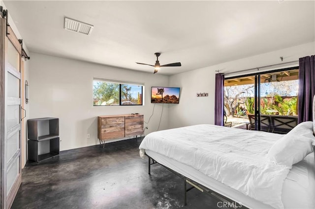 bedroom featuring visible vents, a barn door, a ceiling fan, access to outside, and concrete floors