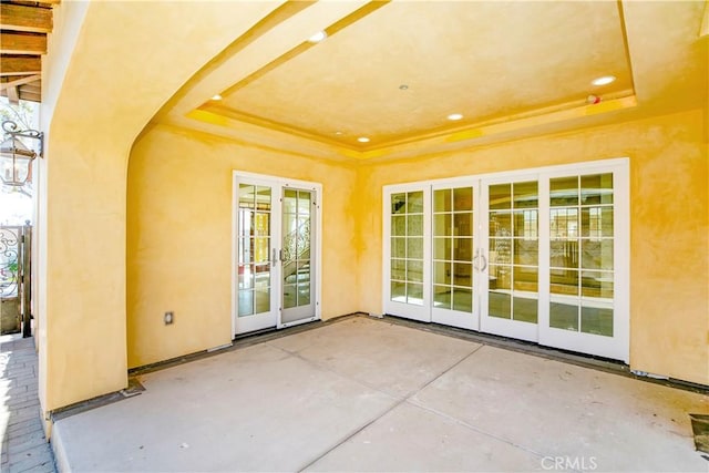 property entrance with a patio and french doors