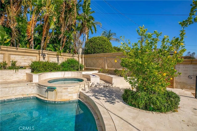 view of pool with an in ground hot tub, fence, and a fenced in pool