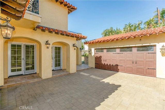 exterior space with a garage and french doors