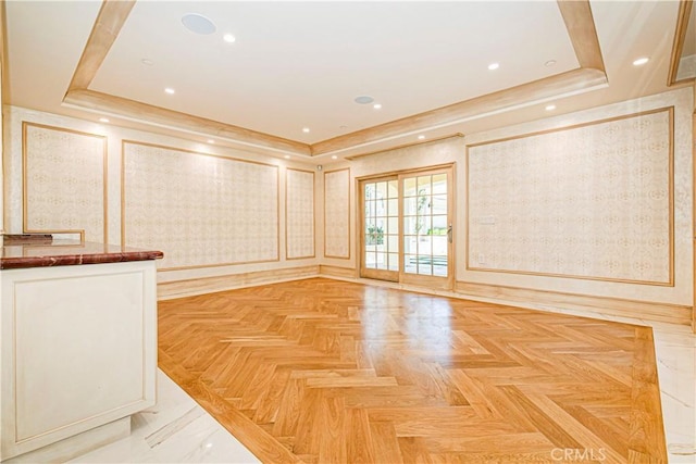 spare room with crown molding, wallpapered walls, a tray ceiling, and recessed lighting