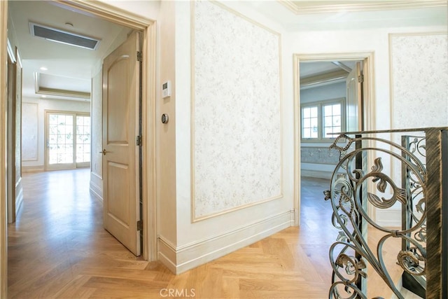 corridor with baseboards, crown molding, visible vents, and a wealth of natural light