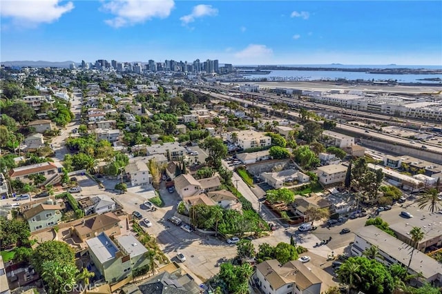 birds eye view of property featuring a water view and a city view