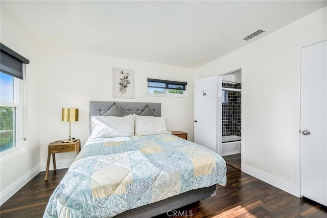 bedroom featuring dark wood-style flooring, visible vents, and baseboards